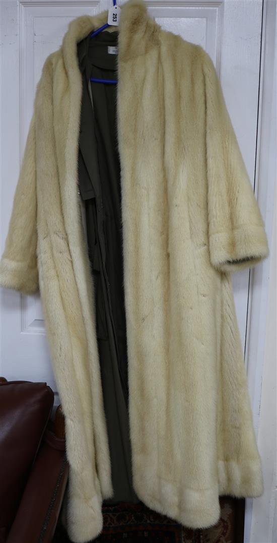 A blonde full length mink fur coat with detachable rain coat